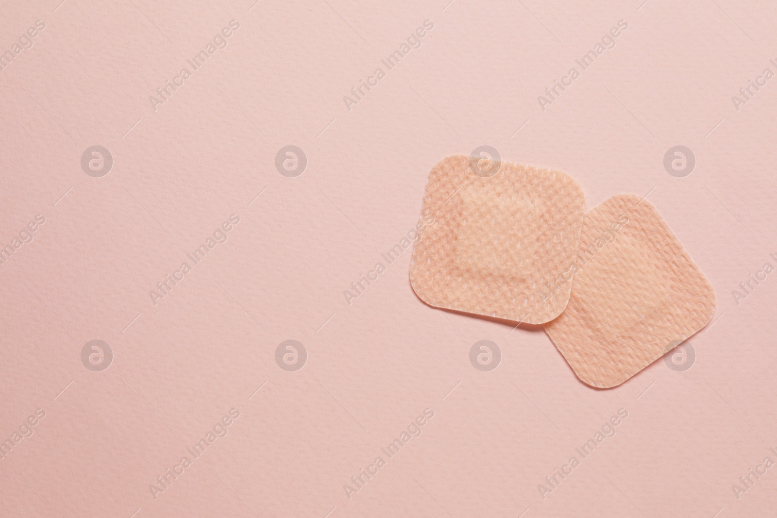 Photo of Contraceptive patches on pink background, flat lay. Space for text