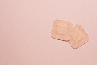 Photo of Contraceptive patches on pink background, flat lay. Space for text