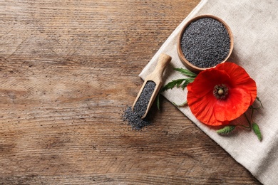 Flat lay composition with poppy seeds and flower on wooden table, space for text