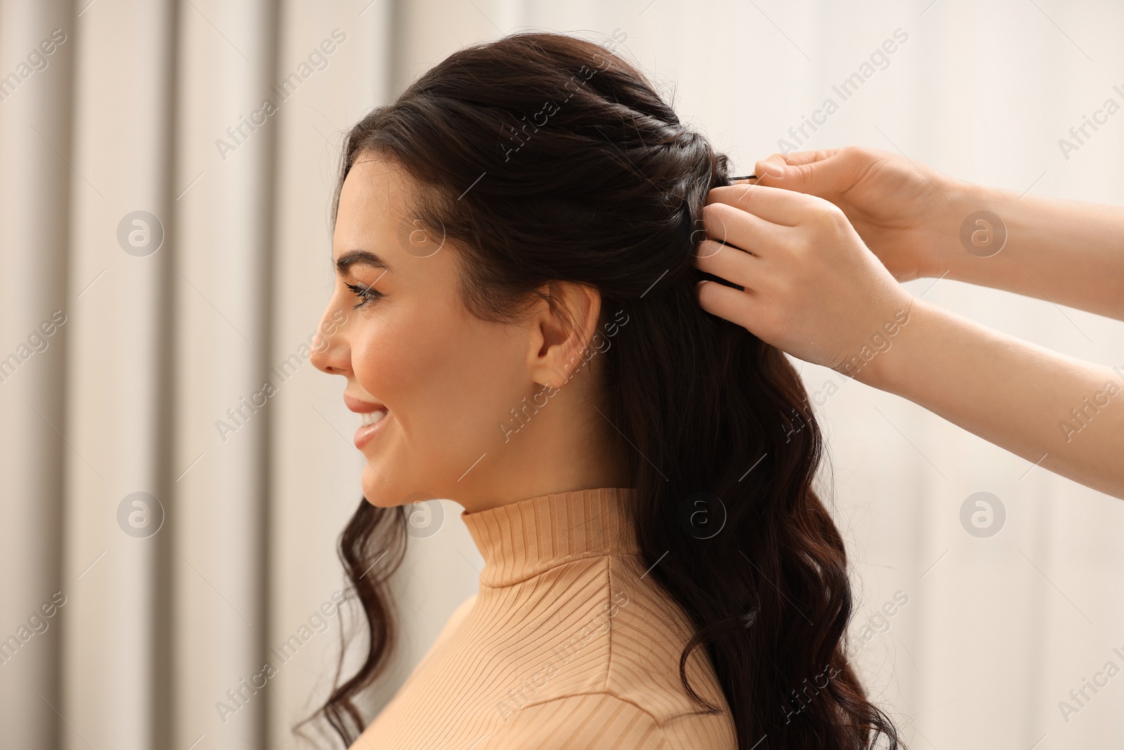 Photo of Hair styling. Professional hairdresser working with smiling client indoors, closeup