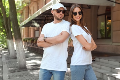 Young couple wearing white t-shirts on street