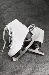 Photo of Pair of white ice skates on grey table