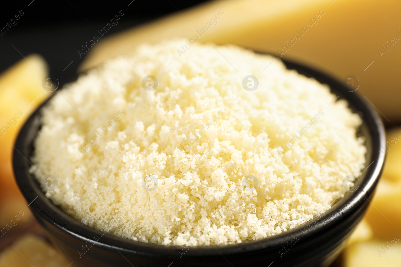 Photo of Bowl with grated parmesan cheese, closeup view