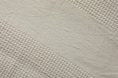 Texture of beige knitted fabric as background, top view