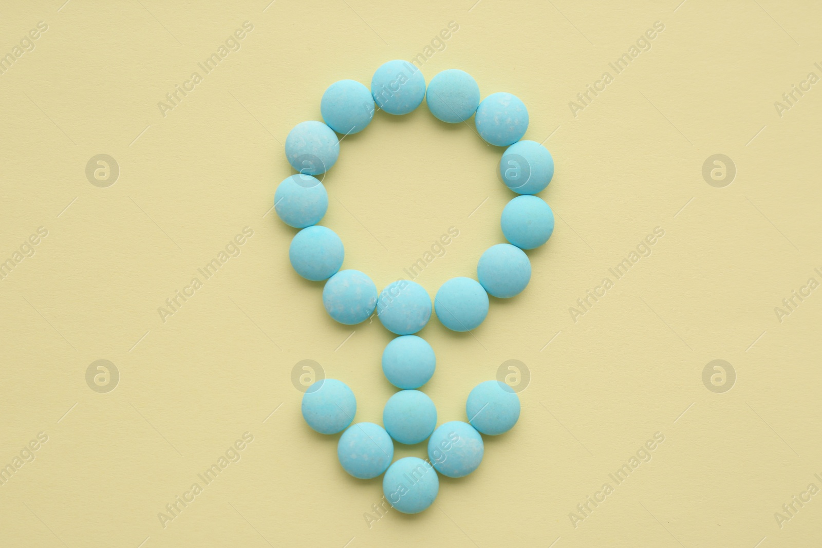 Photo of Male sign made of blue pills on beige background, flat lay. Potency problems