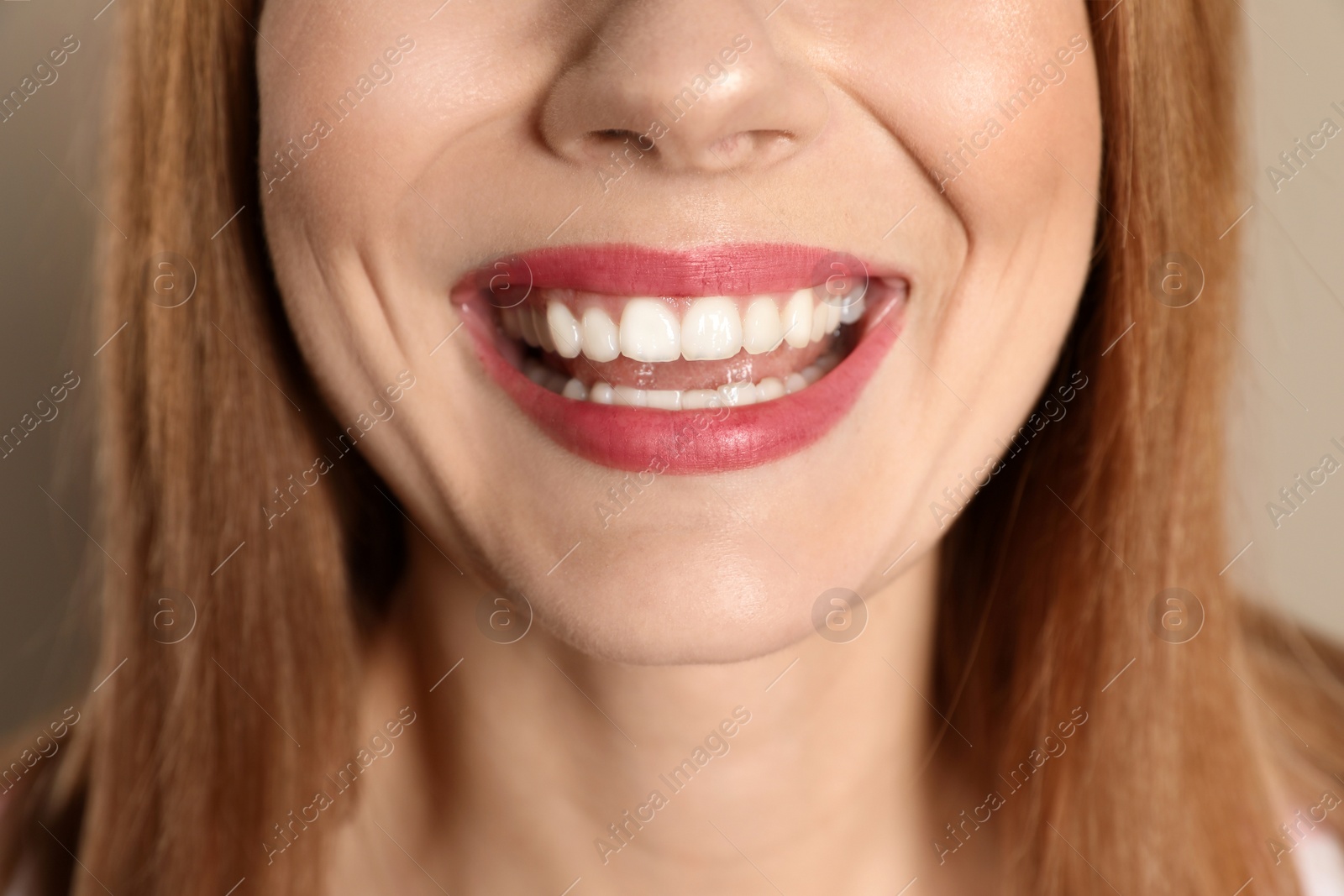 Photo of Smiling woman with perfect teeth on color background, closeup