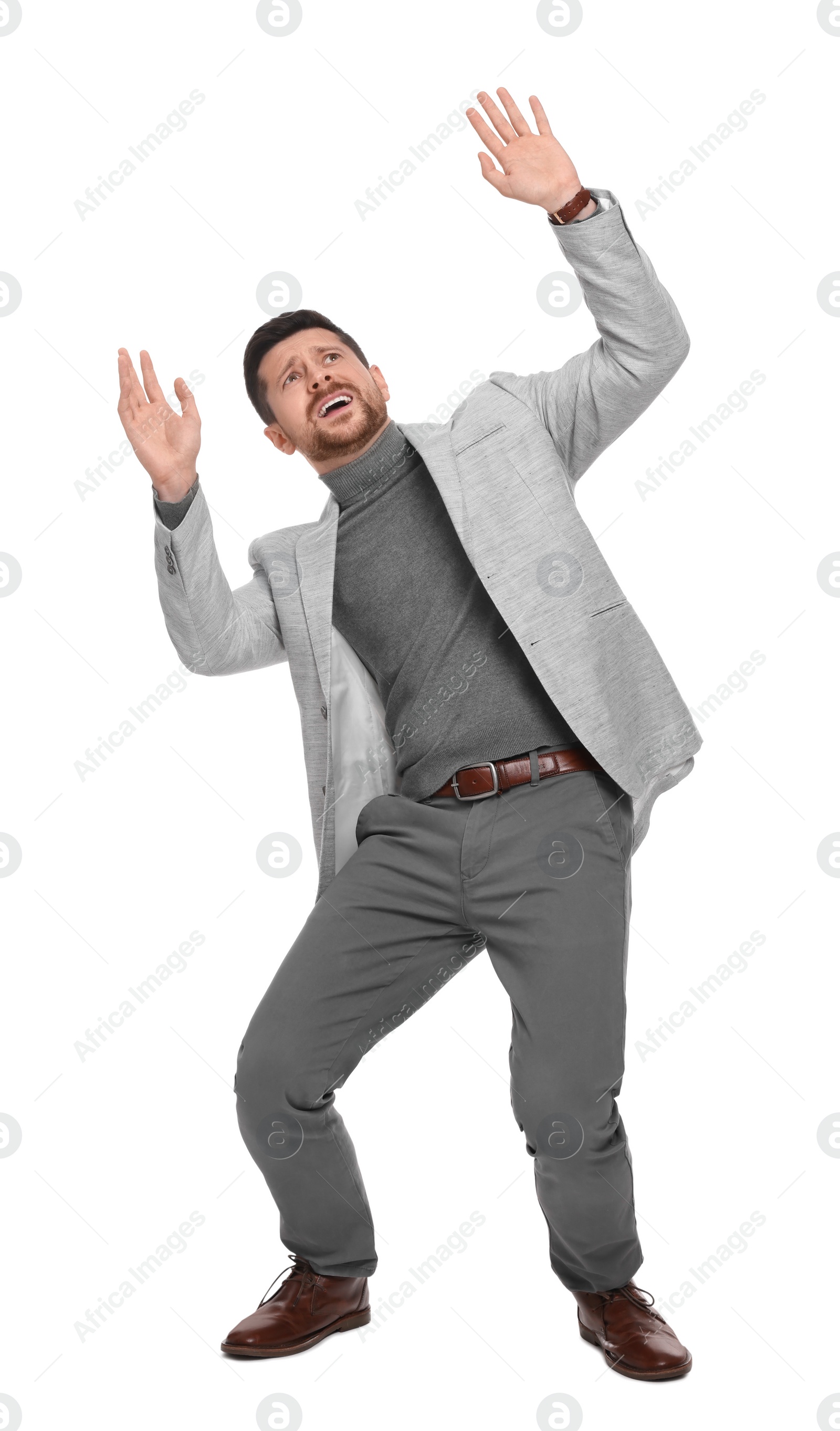 Photo of Emotional bearded businessman in suit evading something on white background