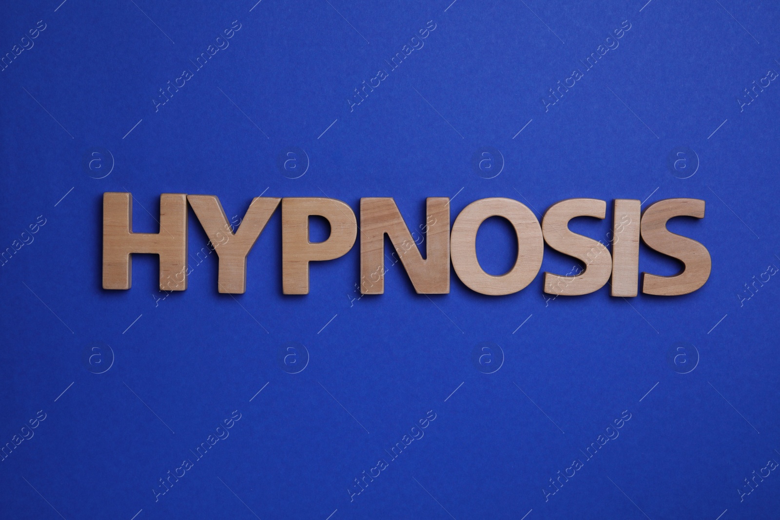 Photo of Word HYPNOSIS made with wooden letters on blue background, flat lay
