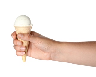 Woman holding delicious ice cream in wafer cone on white background, closeup