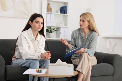 Photo of Psychologist working with teenage girl in office. Teenager problems