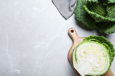 Photo of Fresh savoy cabbages on light marble table, flat lay. Space for text