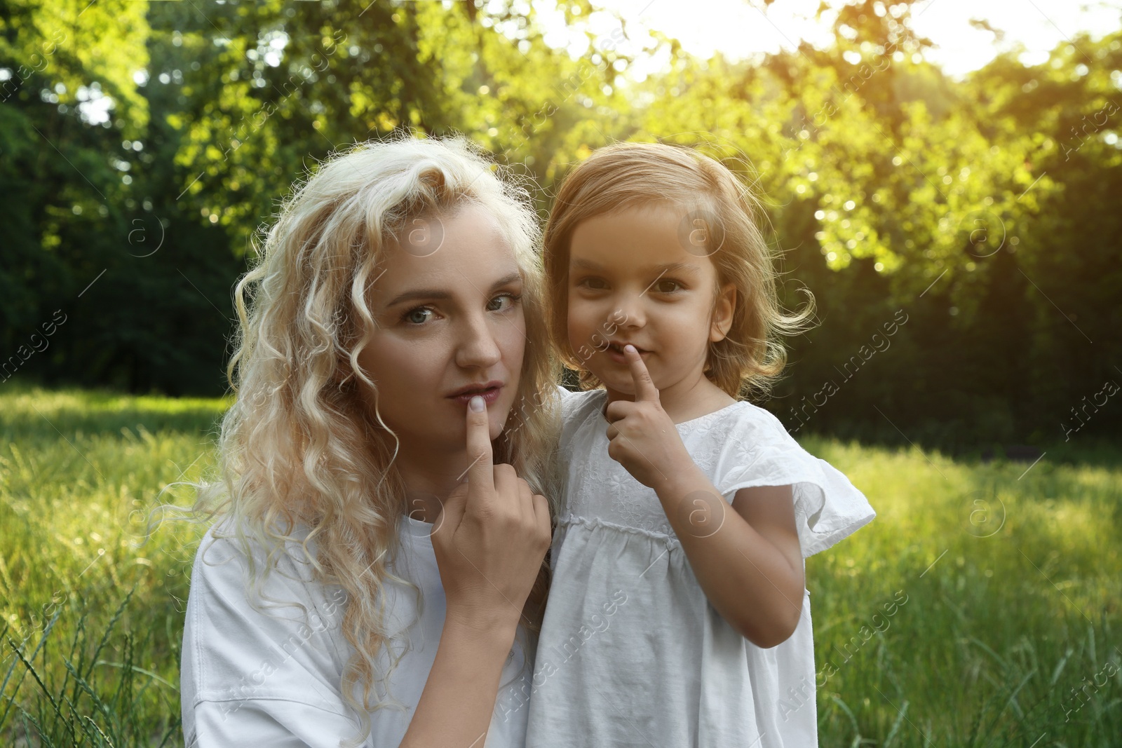 Photo of Beautiful mother with her cute daughter spending time together outdoors