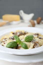 Delicious ravioli with mushrooms and cheese served on table, closeup