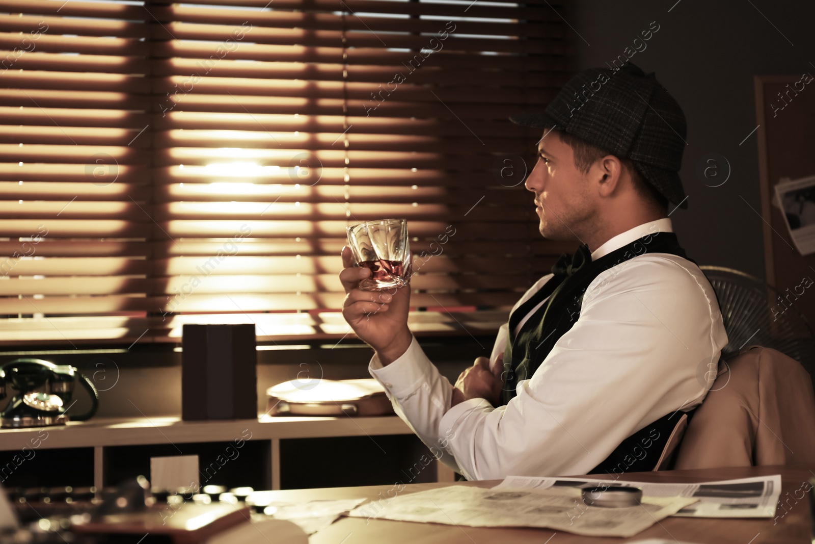 Photo of Old fashioned detective with drink at table in office