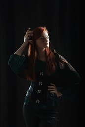 Photo of Beautiful redhead elf girl on black background