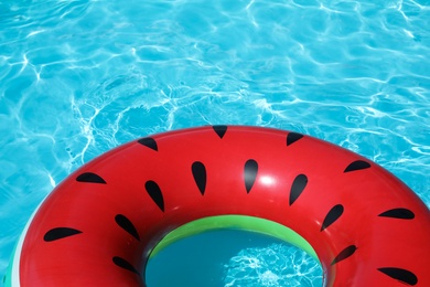 Photo of Inflatable ring floating in swimming pool on sunny day