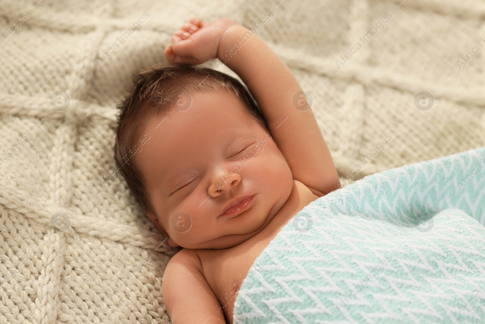 Photo of Cute newborn baby sleeping on beige blanket, closeup