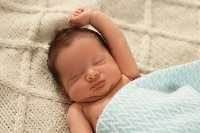 Photo of Cute newborn baby sleeping on beige blanket, closeup