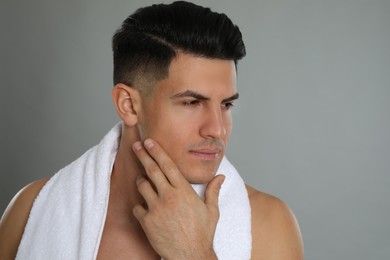 Photo of Handsome man after shaving on grey background