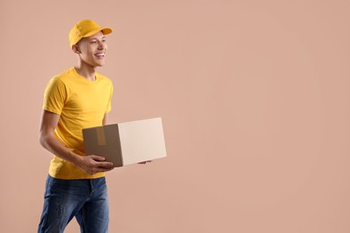 Happy courier with parcel on beige background. Space for text