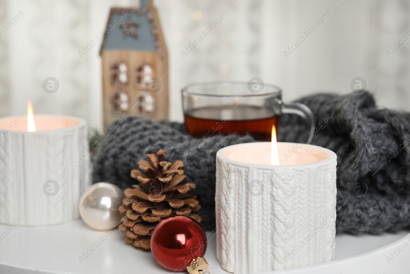 Photo of Composition with candles in ornate holders on table. Christmas decoration