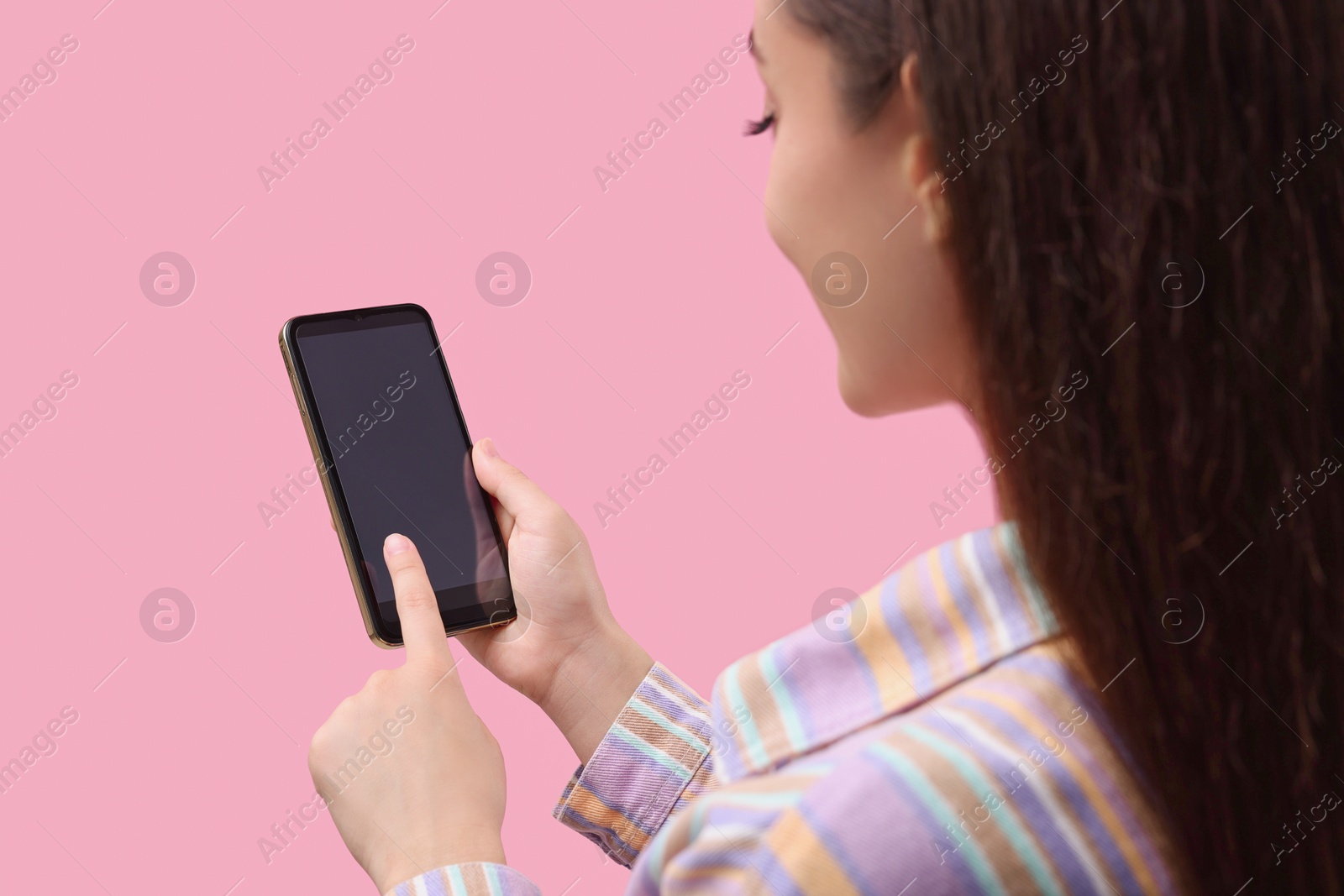 Photo of Woman using smartphone on pink background, closeup. Mockup for design