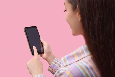 Photo of Woman using smartphone on pink background, closeup. Mockup for design