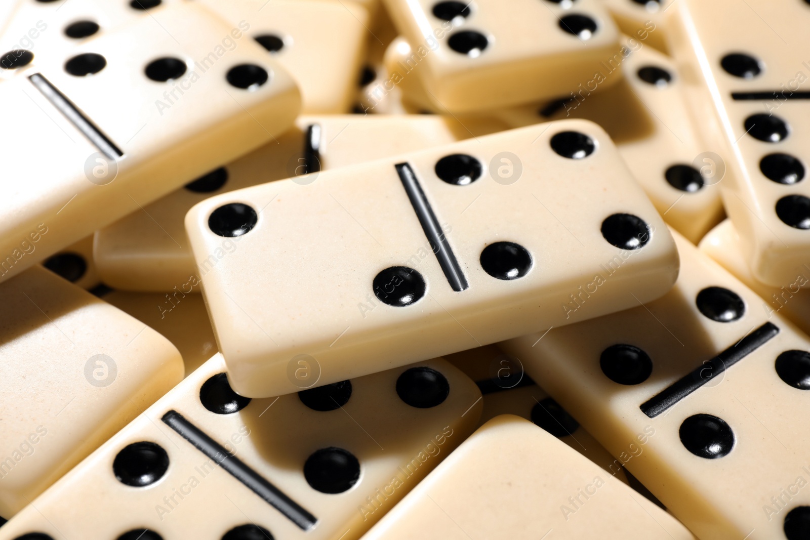 Photo of Set of classic domino tiles as background, closeup