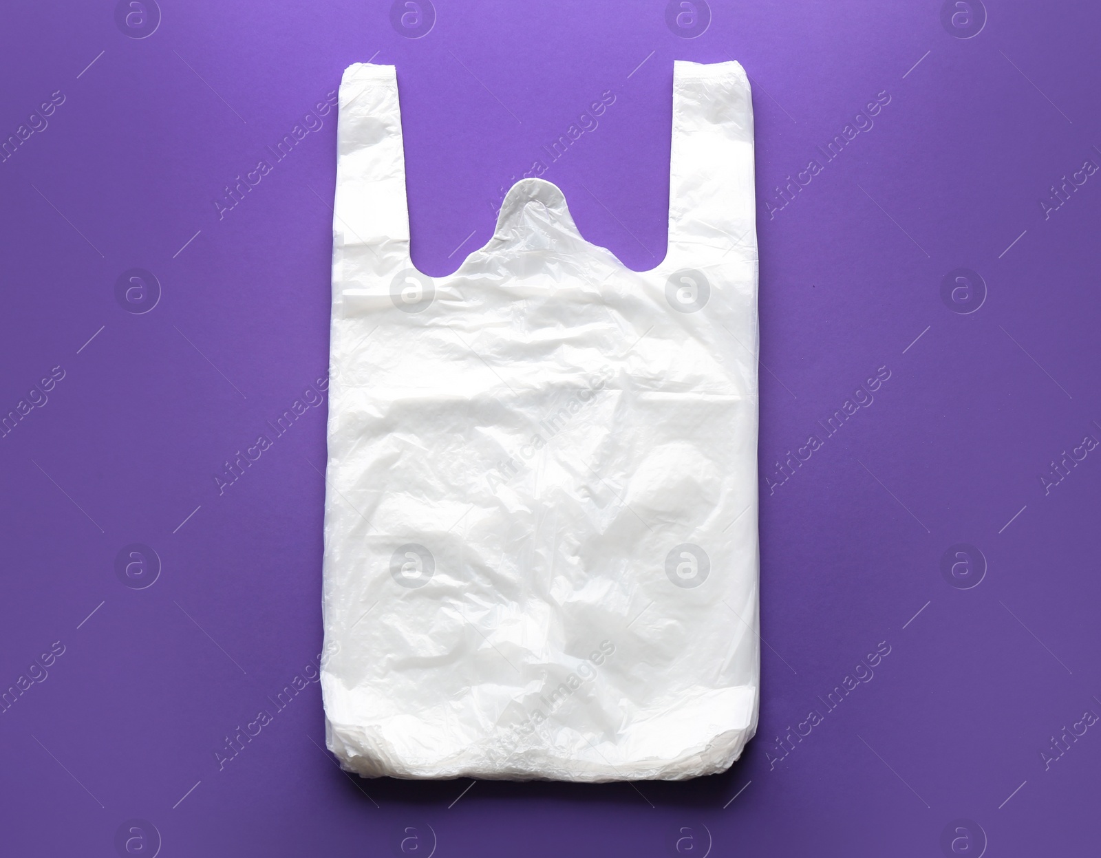 Photo of Clear disposable plastic bags on color background