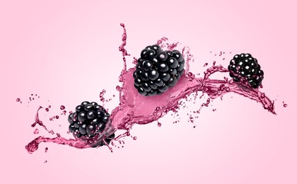 Image of Fresh blackberries and juice in air on pink background