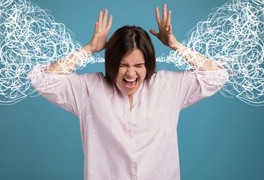 Image of Stressed and upset young woman on blue background