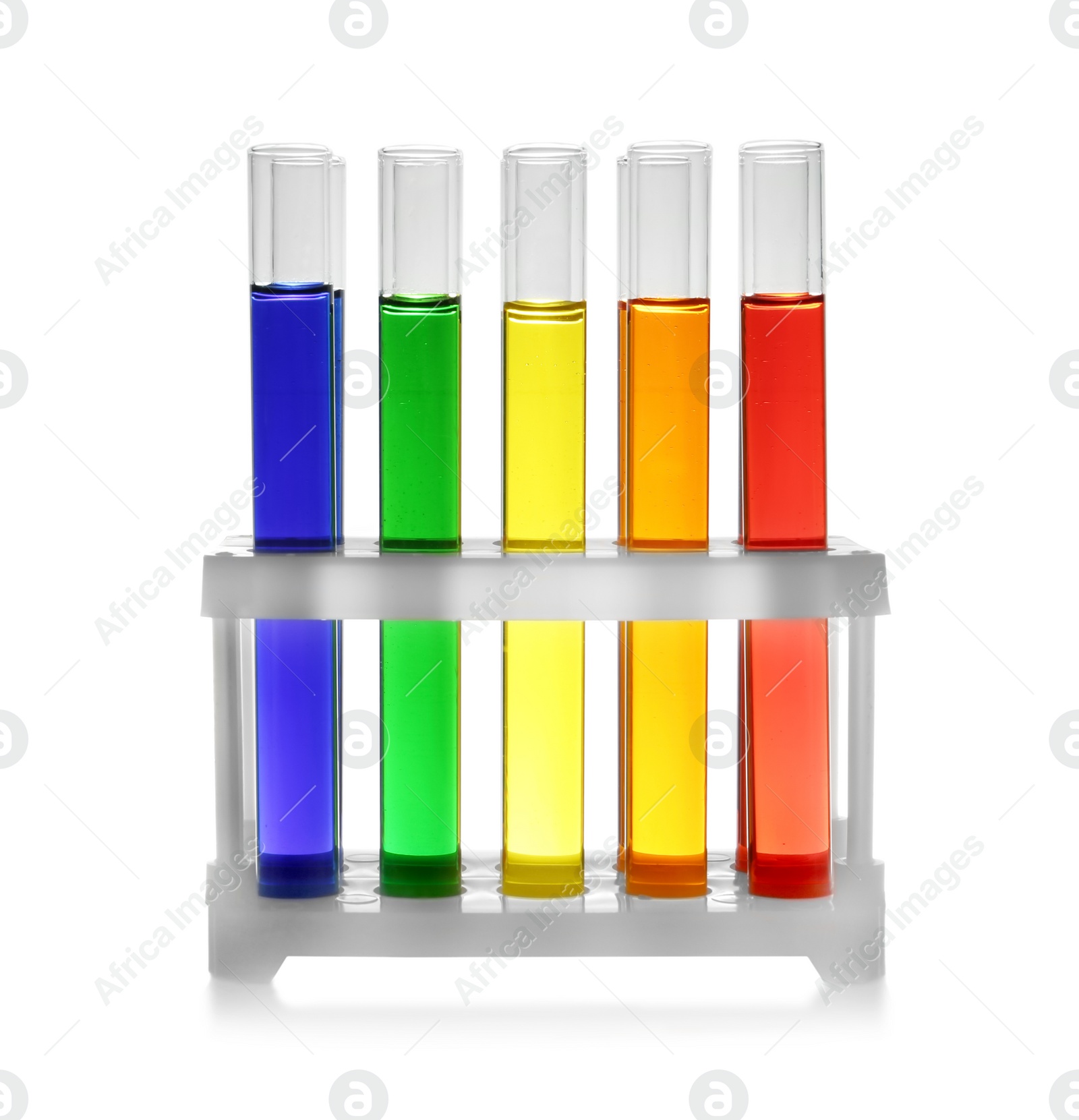 Photo of Rack with test tubes of color liquid isolated on white. Solution chemistry