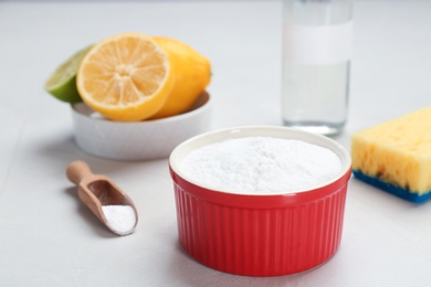 Bowl and scoop with baking soda on gray table