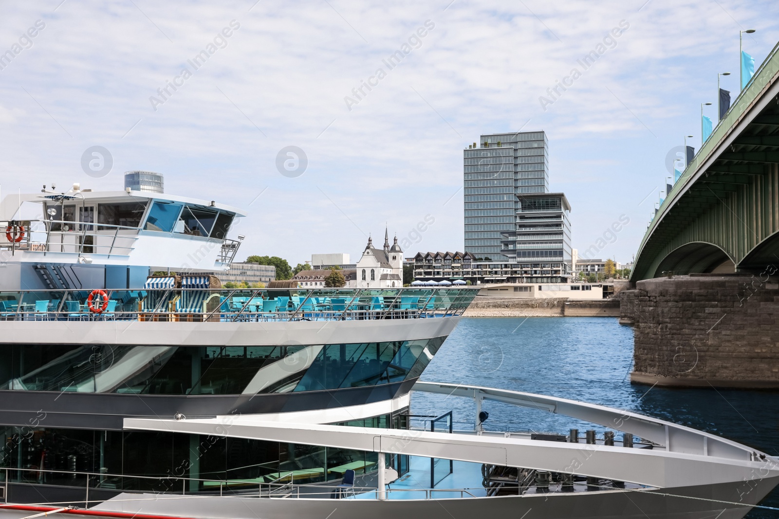 Photo of Modern ferry ship near bridge on sunny day