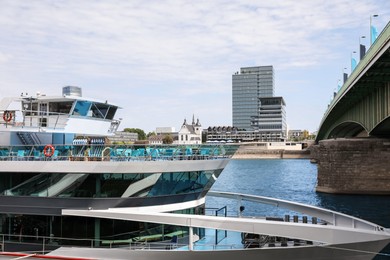 Modern ferry ship near bridge on sunny day