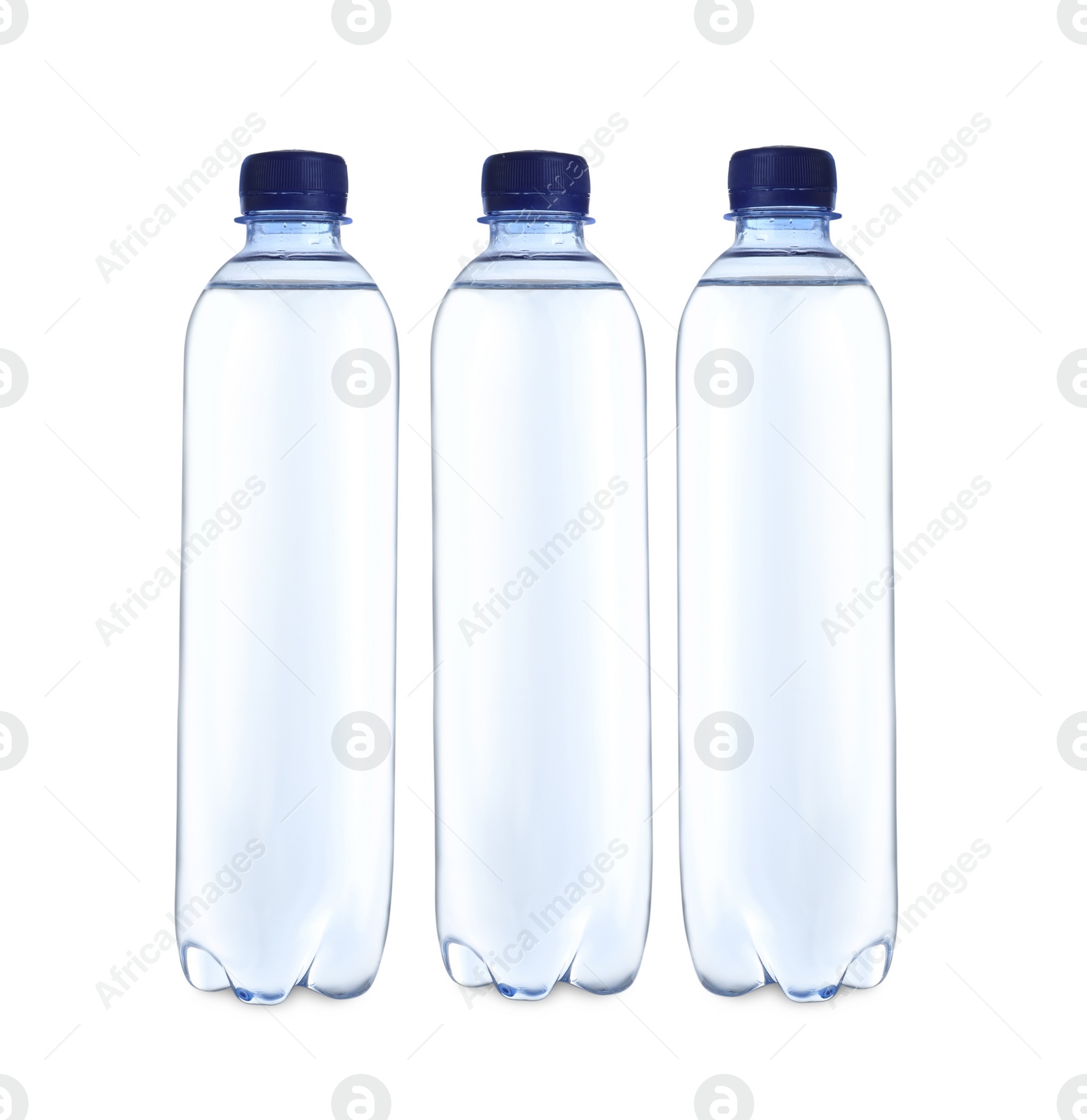 Photo of Plastic bottles with water on table against white background