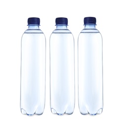 Photo of Plastic bottles with water on table against white background