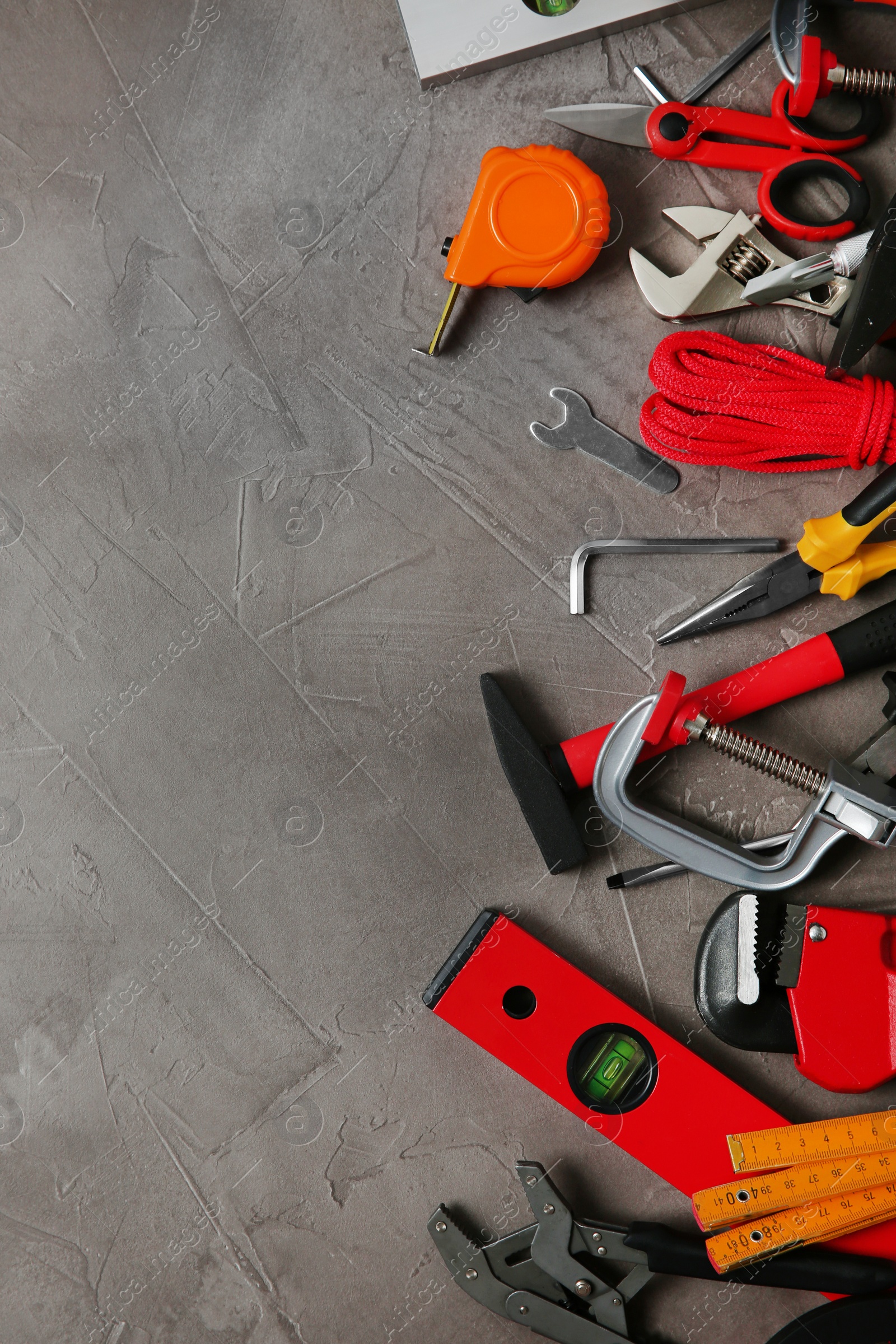 Photo of Flat lay composition with repair tools on grey stone table, space for text