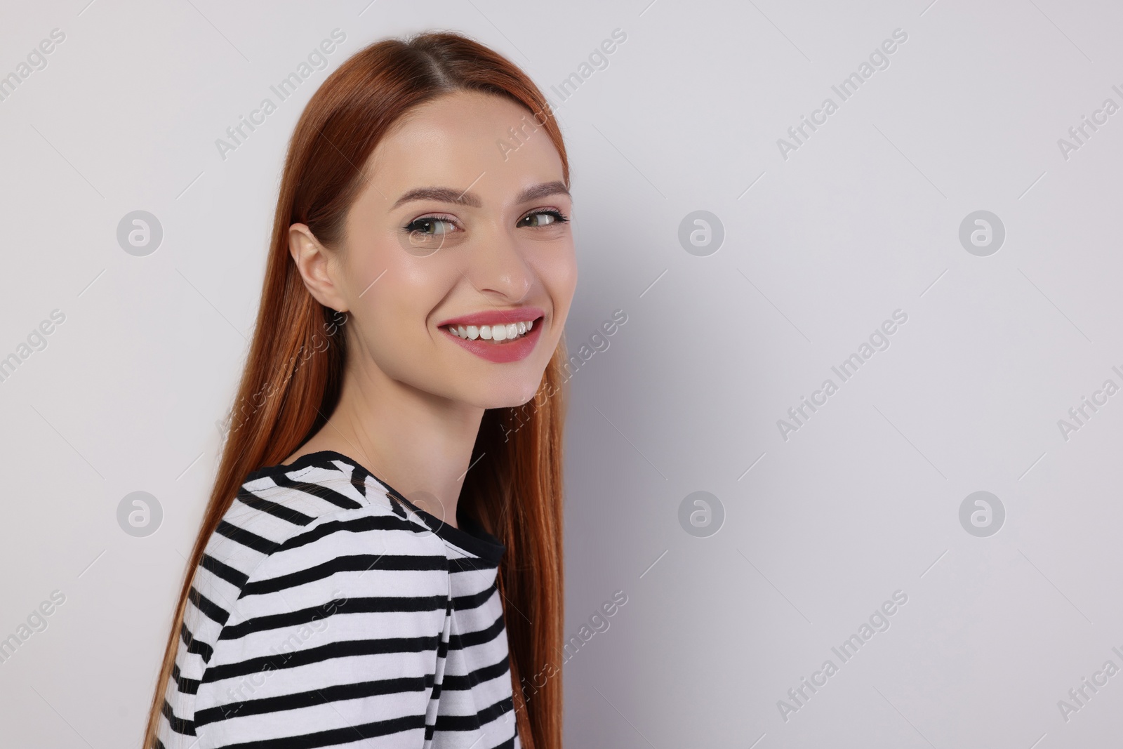 Photo of Portrait of beautiful young woman on light gray background, space for text