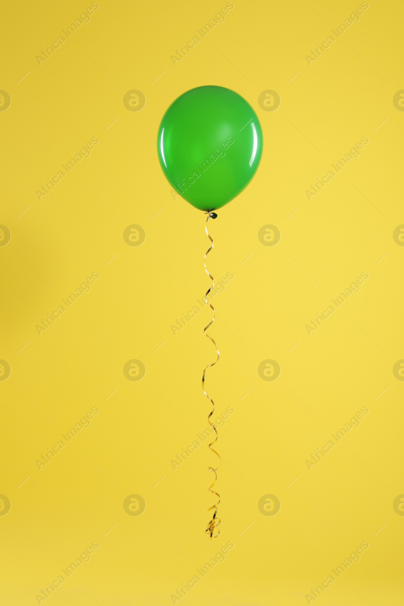 Photo of Bright balloon on color background. Celebration time