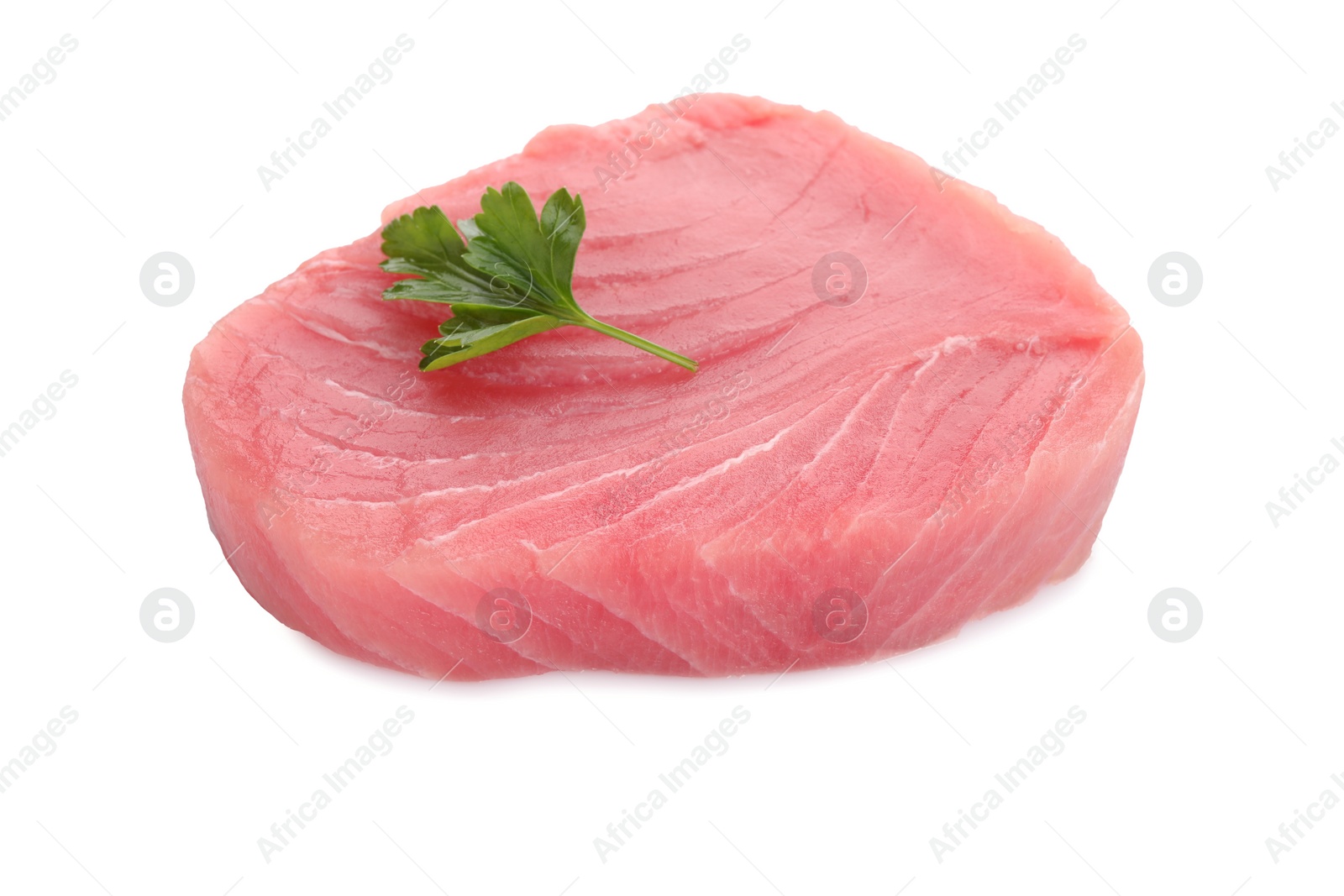Photo of Raw tuna fillet and parsley leaf isolated on white