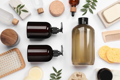 Flat lay composition with solid shampoo bar and bottles of cosmetic product on white background