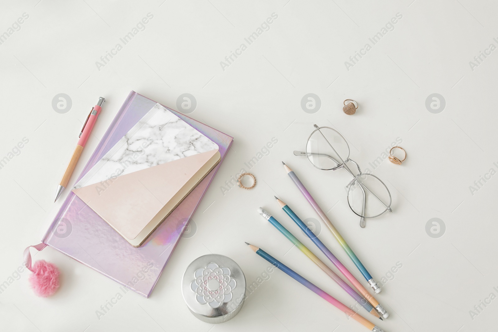 Photo of Flat lay composition with notebooks and glasses on light background. Blogger's workplace