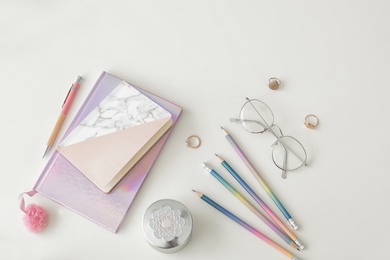 Photo of Flat lay composition with notebooks and glasses on light background. Blogger's workplace