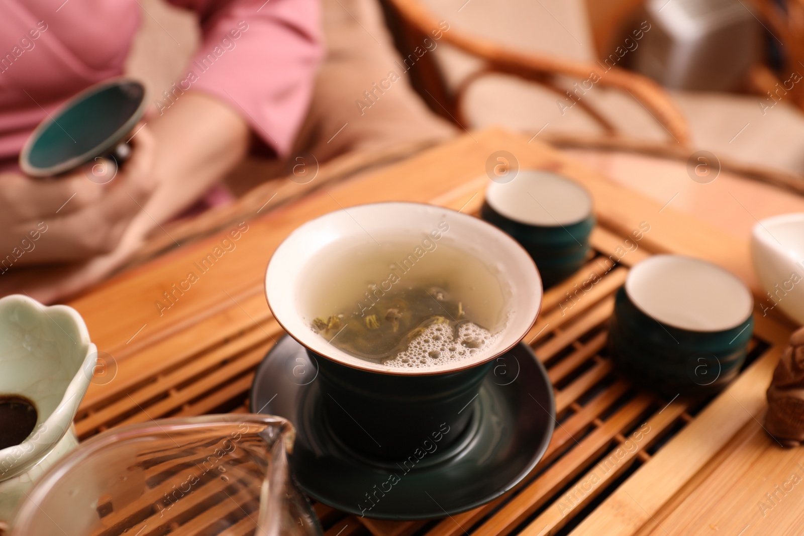 Photo of Traditional tea ceremony. Master near tools and tray, closeup