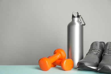 Photo of Composition with fitness equipment on light table, space for text