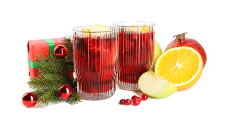 Aromatic Sangria drink in glasses, ingredients and Christmas decor isolated on white