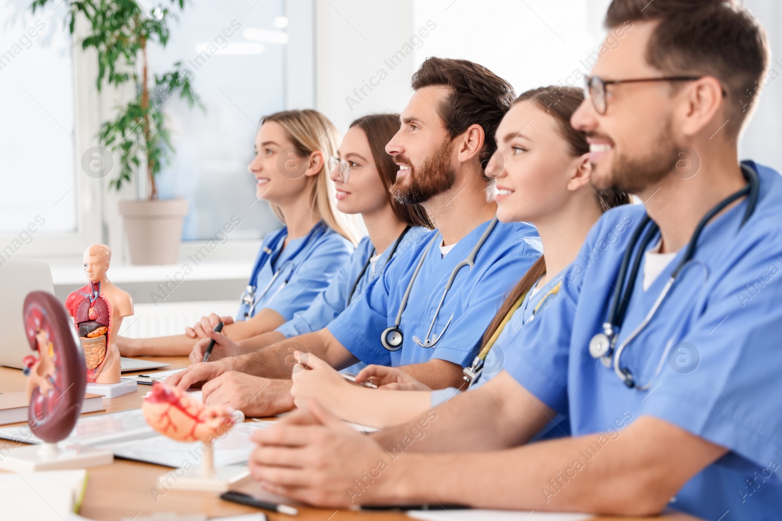 Photo of Medical students in uniforms studying at university