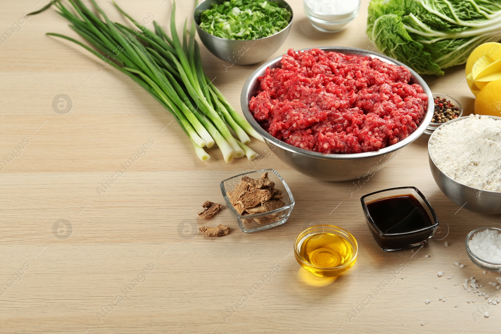 Photo of Composition with gyoza ingredients on wooden table, space for text