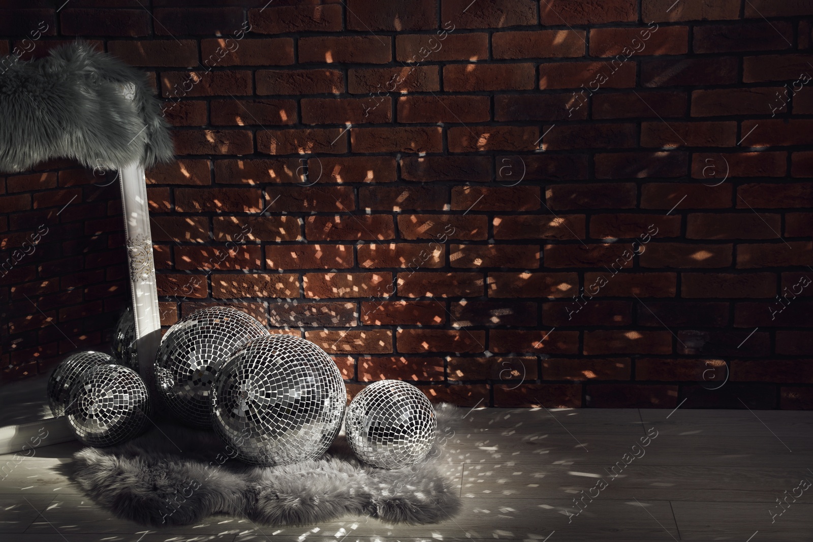 Photo of Many shiny disco balls in dark room. Space for text